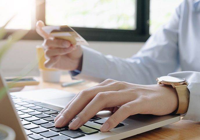 Online payment,woman's hands holding credit card using laptop for online shopping.